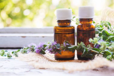 Thyme essential oil in a small bottle. selective focus .nature