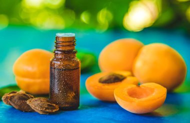 Apricot kernel oil in a bottle. Selective focus.
