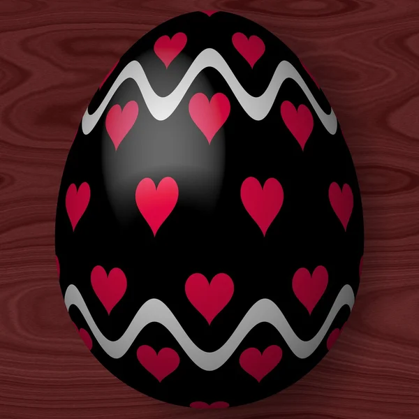 Black decorated Easter egg with hearts and wavy lines on wooden texture — Stock Photo, Image