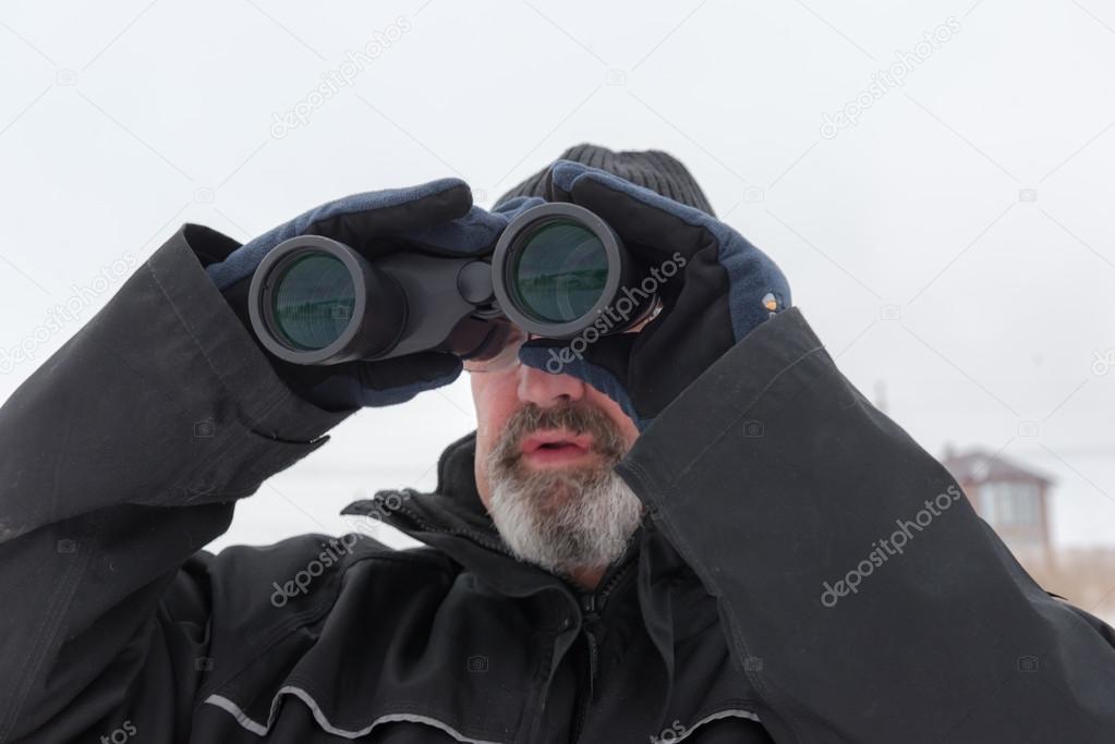 Man with binoculars. January 2, 2015, Ukraine, Dnepropetrovsk.