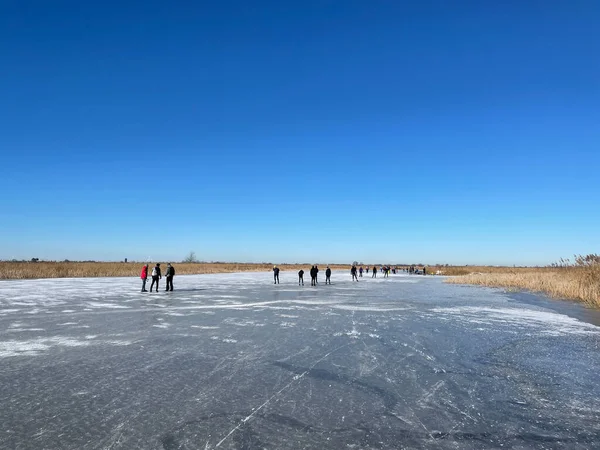 People ice skating on a frozen lake around Sneek in Friesland The Netherlands