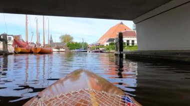 Canoeing towards downtown Heeg in The Netherlands