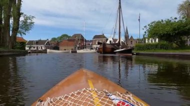 Canoeing through downtown Heeg in The Netherlands