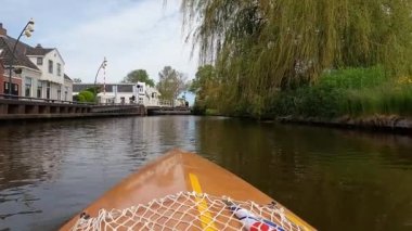 Canoeing through downtown Heeg in The Netherlands
