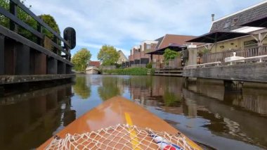 Canoeing through downtown Heeg in The Netherlands