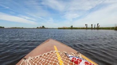 Canoeing on a lake around Heeg in The Netherlands