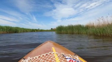 Canoeing on a canal towards Oudega in Friesland, The Netherlands