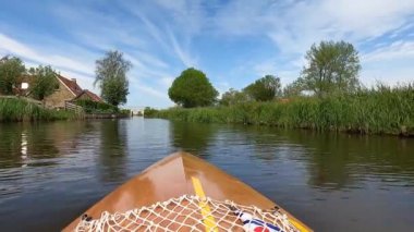Canoeing on a canal towards Oudega in Friesland, The Netherlands
