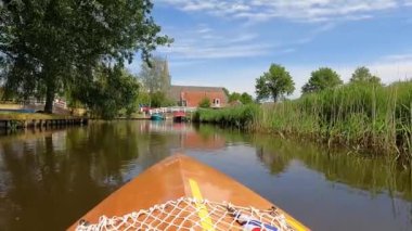 Canoeing on a canal in Oudega Friesland, The Netherlands