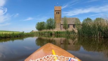 Canoeing on a canal in Westhem Friesland, The Netherlands