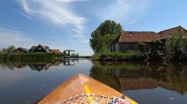 Canoeing on a canal towards Abbegea in Friesland, The Netherlands