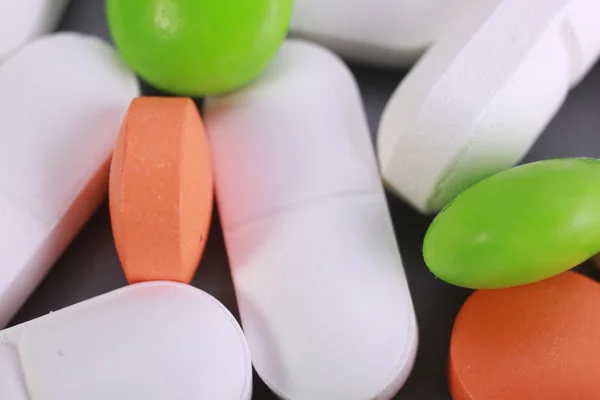 Red and white pill capsules pile — Stock Photo, Image