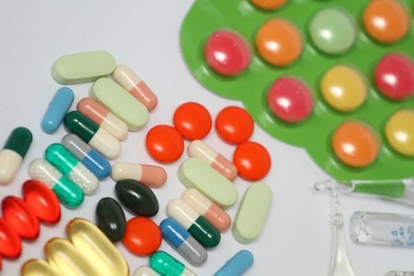 A pile of colorful medications tablets - medical background — Stock Photo, Image