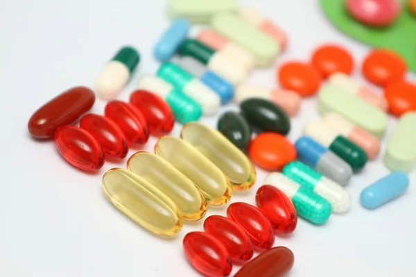 A pile of colorful medications tablets - medical background — Stock Photo, Image