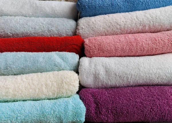 Toalhas de algodão terry multi-coloridas são empilhadas — Fotografia de Stock