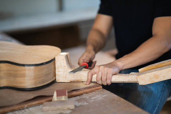 craft man making guitar on wood table, capenter working concept