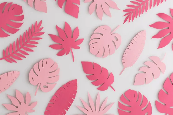 Tropical pink paper leaves on white background.Summer concept. Top view, flat lay.