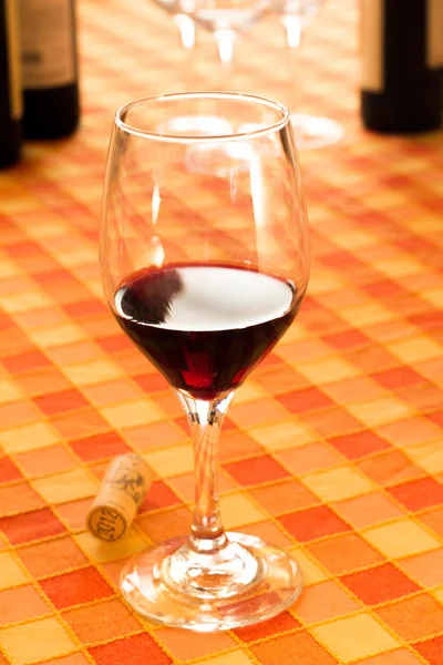 Glass of red wine in the rustic tablecloth — Stock Photo, Image
