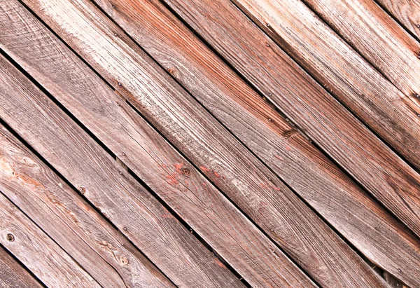 diagonal slanted barn wall siding boards weathered faded and worn as an interior or exterior design architectural scene