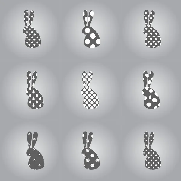 Siluetas estilizadas de conejo sobre fondo gris — Archivo Imágenes Vectoriales