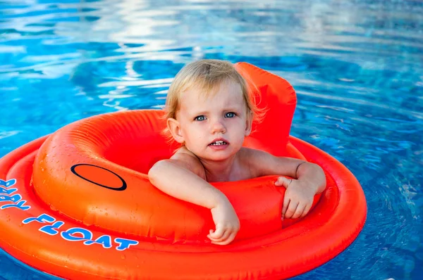 Baby swimming in the orange float — Stock Photo, Image