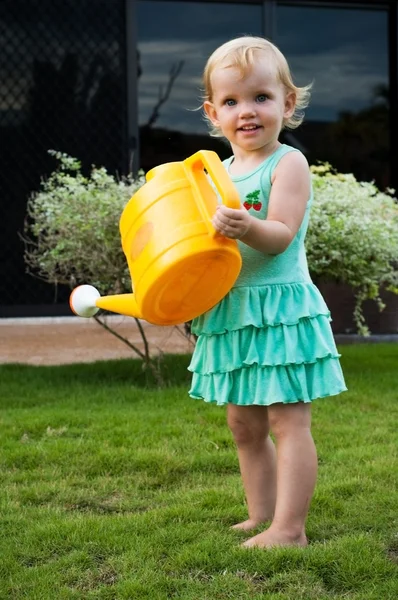 Baby girl with the watering can — Stock Photo, Image