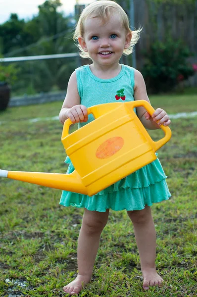 Baby girl with the watering can — Stock Photo, Image