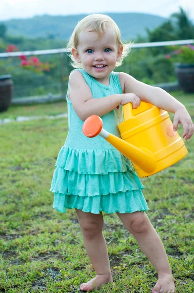 Baby girl with the watering can — Stock Photo, Image