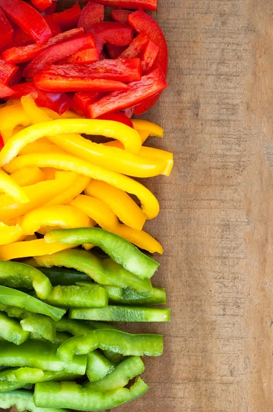 Sliced colourful paprika peppers background — Stock Photo, Image