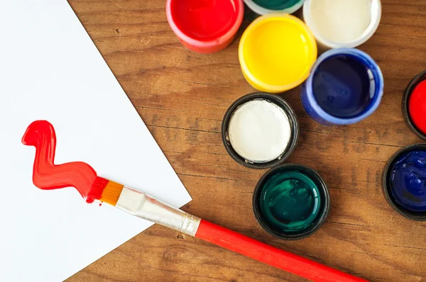 Watercolors and brushes on wooden background — Stock Photo, Image