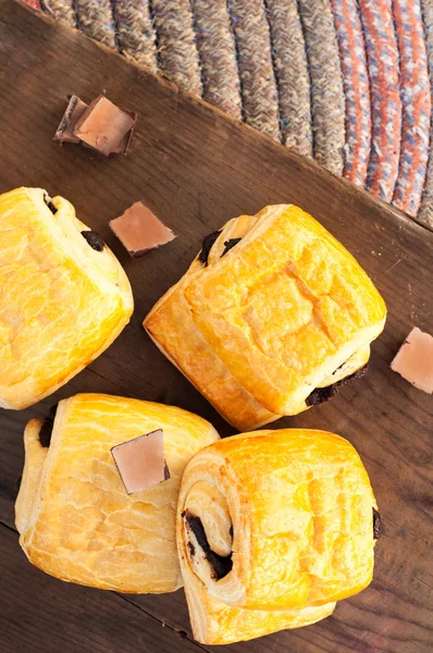 Chocolate croissants on wooden background — Stock Photo, Image