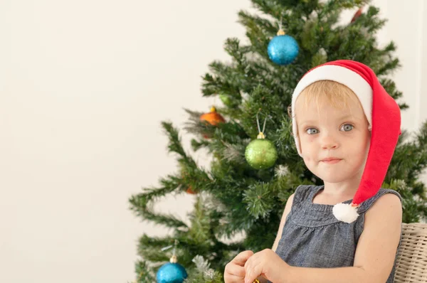 Little girl posing near the christmas tree — Stock Photo, Image