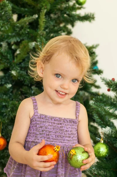 Little girl posing near the christmas tree — Stock Photo, Image