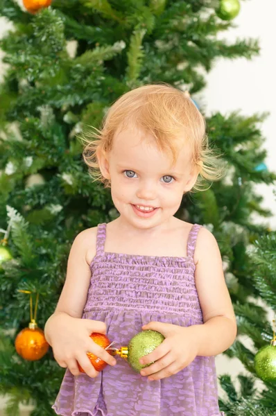 Little girl posing near the christmas tree — Stock Photo, Image