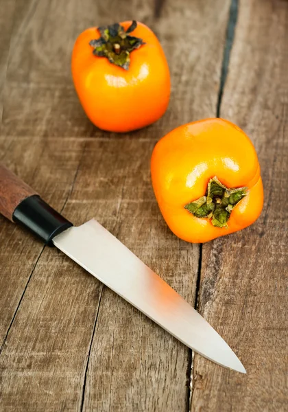 Fresh ripe persimmon on a wooden table — Stock Photo, Image