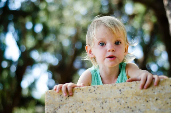 Surprised toddler girl looking right in camera shallow focus — Stock Photo, Image