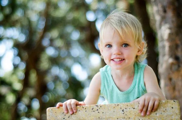 Adorable toddler girl looking right in camera shallow focus — Stock Photo, Image