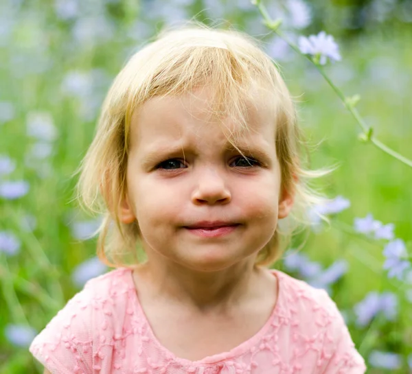 Little girl with a cute grumpy face expression — Stock Photo, Image