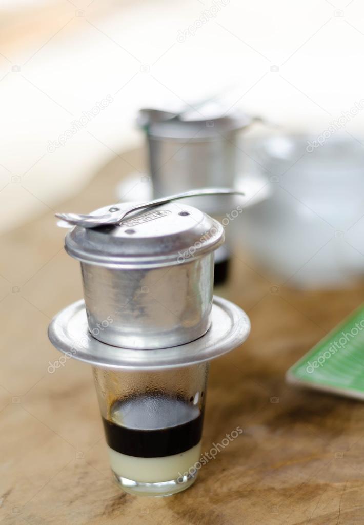 Vietnamese style coffee filters on wooden table