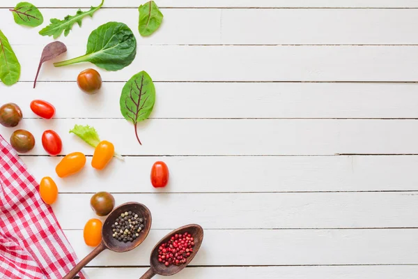 Healthy cooking background: fresh cooking ingredients, spices on white wooden background