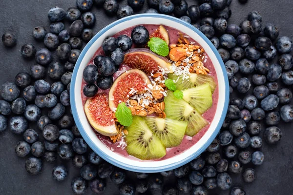 Blueberry Acai Smoothie Bowl With Kiwi, Figs, Granola And Coconut. Top View. Healthy Vegan Smoothie