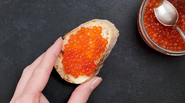 Красная икра и масло на ломтике белого хлеба — стоковое фото