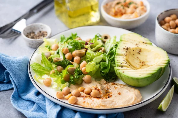 Salad bowl with avocado, hummus and greens — Stock Photo, Image