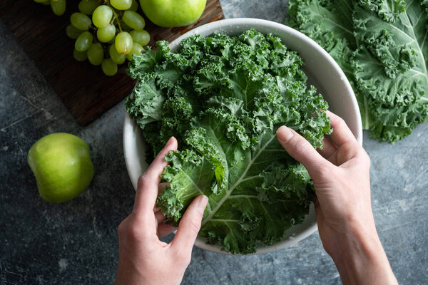 Hands washing kale cabbage