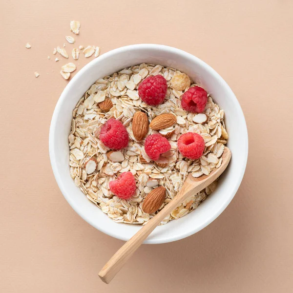 Dry oat muesli with almonds and fresh raspberries