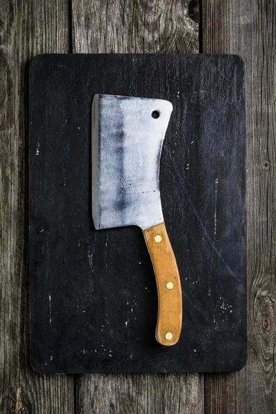 블랙 커팅 보드에 오래 된 고기 칼 — 스톡 사진