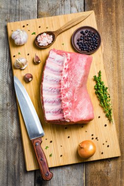Raw pork chops,spices and vegetables on wooden cutting board. Cooking food. Top view