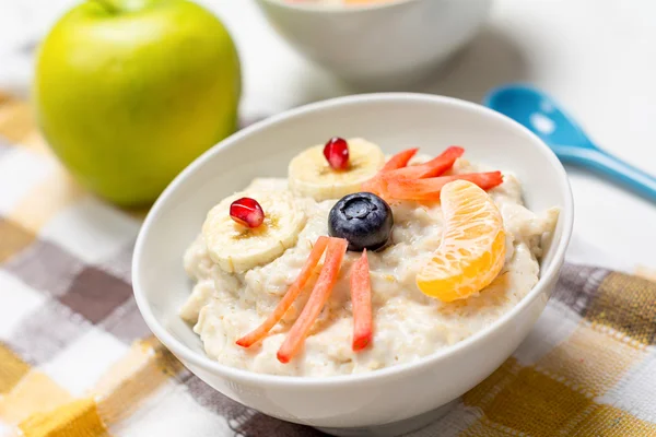 Oatmeal porridge, healthy breakfast for kids. Funny food for children