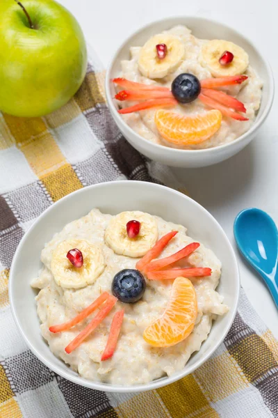 Oatmeal porridge, healthy breakfast for kids. Funny food for children