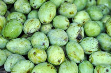 Piles of mangoes on display at a fruit market